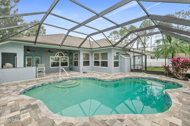 view of pool featuring a patio, ceiling fan, and glass enclosure