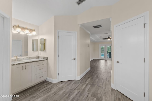 bathroom featuring vanity, wood-type flooring, french doors, and ceiling fan