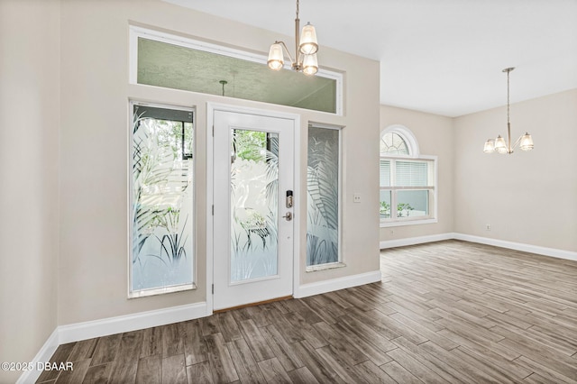 foyer with a chandelier and hardwood / wood-style floors