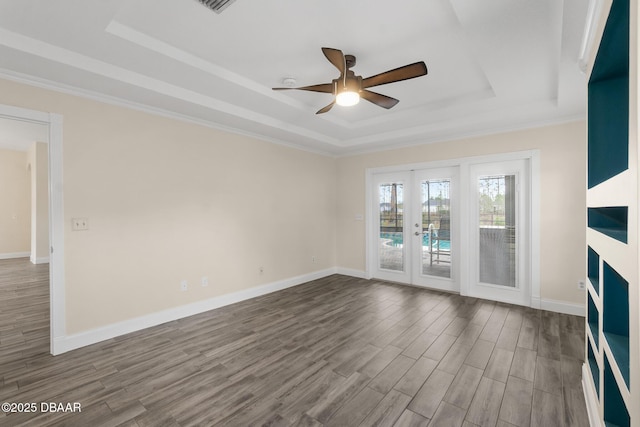 unfurnished living room with crown molding, hardwood / wood-style flooring, ceiling fan, french doors, and a raised ceiling