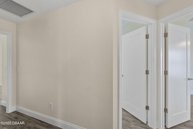 hallway with hardwood / wood-style floors