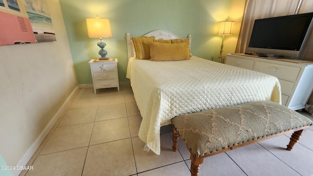 219 S Atlantic Ave Unit 235, Daytona Beach, FL 32118 - bedroom featuring baseboards and light tile patterned floors
