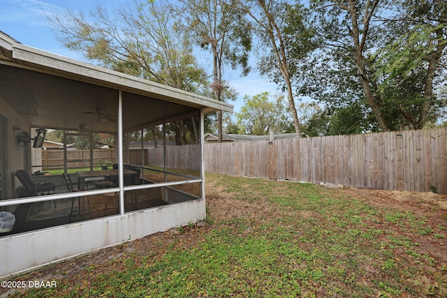 view of yard featuring a sunroom and a fenced backyard