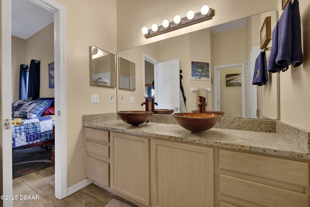 ensuite bathroom with connected bathroom, a sink, and double vanity