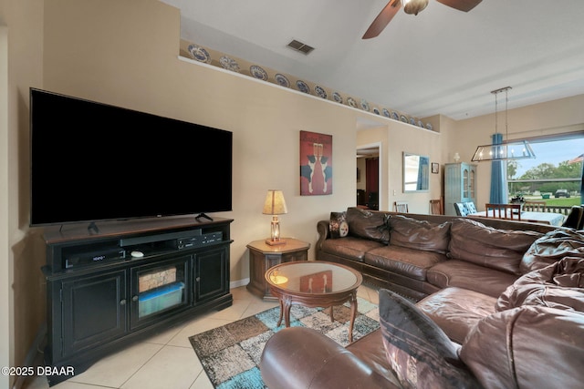 living room featuring light tile patterned floors, visible vents, and a ceiling fan