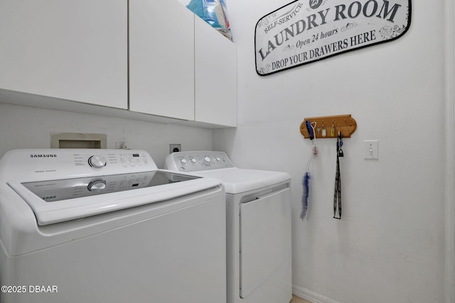 laundry room featuring cabinet space and washer and clothes dryer