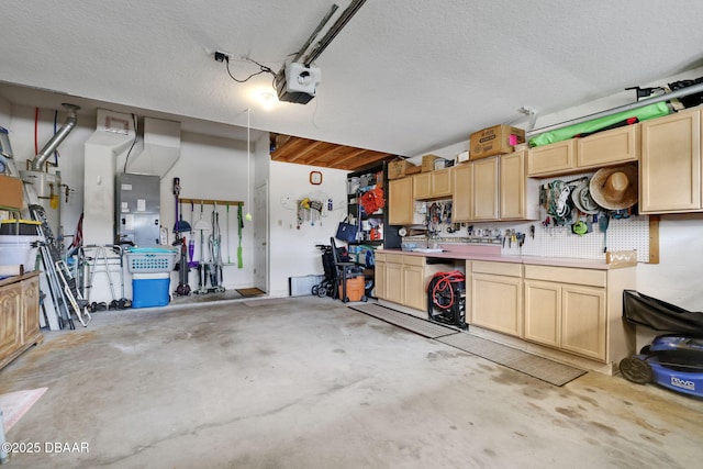 garage featuring a garage door opener and a workshop area