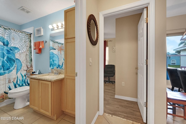 full bathroom with toilet, tile patterned floors, visible vents, and vanity