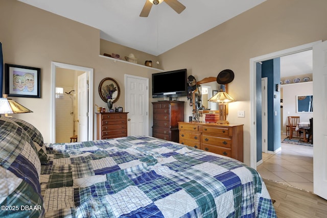 bedroom with light tile patterned floors, ceiling fan, and lofted ceiling