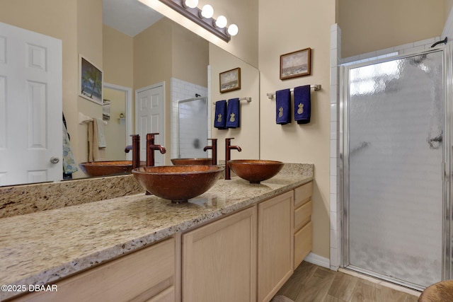 full bath featuring a stall shower and vanity