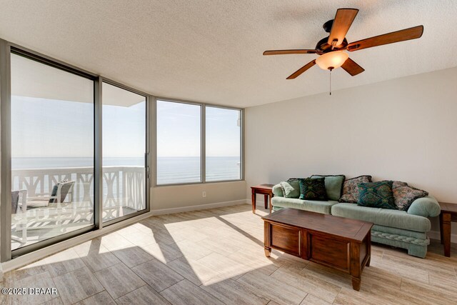 1133 Ocean Shore Blvd Unit 905, Ormond Beach, FL 32176 - living room featuring ceiling fan, wood tiled floors, and a textured ceiling