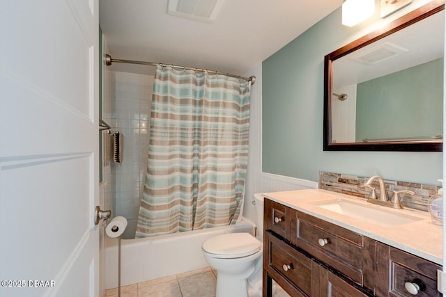 1133 Ocean Shore Blvd Unit 905, Ormond Beach, FL 32176 - full bathroom with shower / bathtub combination with curtain, vanity, toilet, a wainscoted wall, and tile patterned floors