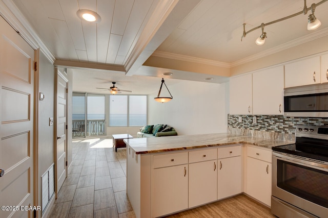 1133 Ocean Shore Blvd Unit 905, Ormond Beach, FL 32176 - kitchen with stainless steel appliances, a peninsula, crown molding, backsplash, and a ceiling fan