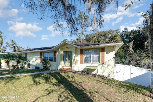 ranch-style home featuring a front yard