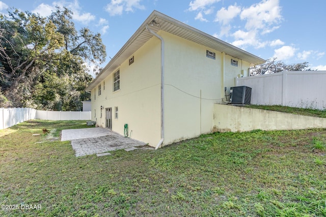 exterior space with a lawn, central AC unit, and a patio