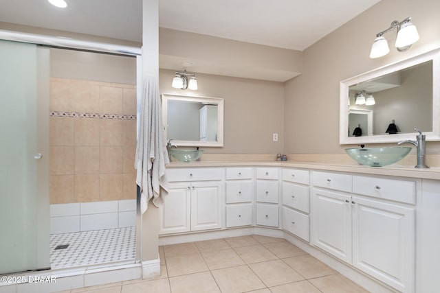 bathroom featuring a shower with door, tile patterned floors, and vanity