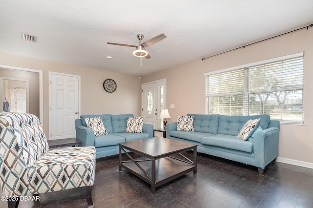 living room featuring a textured ceiling, ceiling fan, and dark hardwood / wood-style flooring