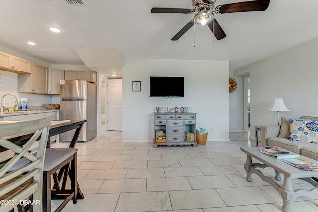 tiled living room featuring sink and ceiling fan