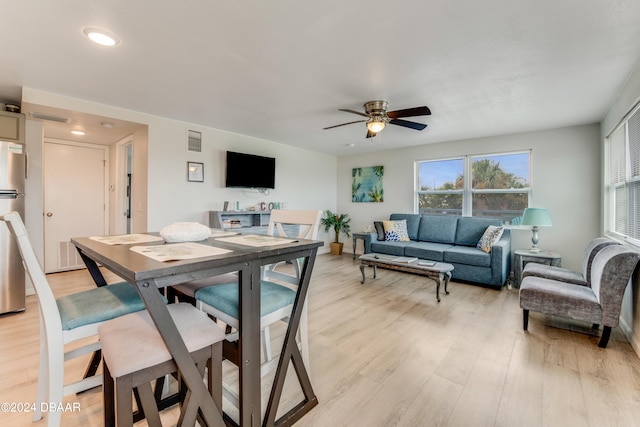 dining room featuring ceiling fan and light hardwood / wood-style floors