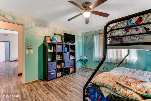 210 Centennial Ln, Daytona Beach, FL 32119 - bedroom featuring wood finished floors, ceiling fan, a textured ceiling, and visible vents