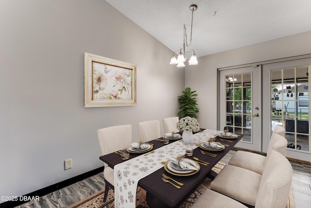 210 Centennial Ln, Daytona Beach, FL 32119 - dining room featuring an inviting chandelier, wood finished floors, baseboards, french doors, and vaulted ceiling