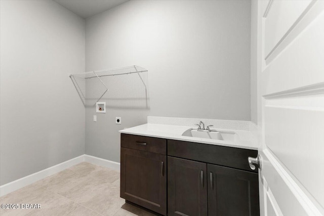 washroom with washer hookup, baseboards, hookup for an electric dryer, and a sink