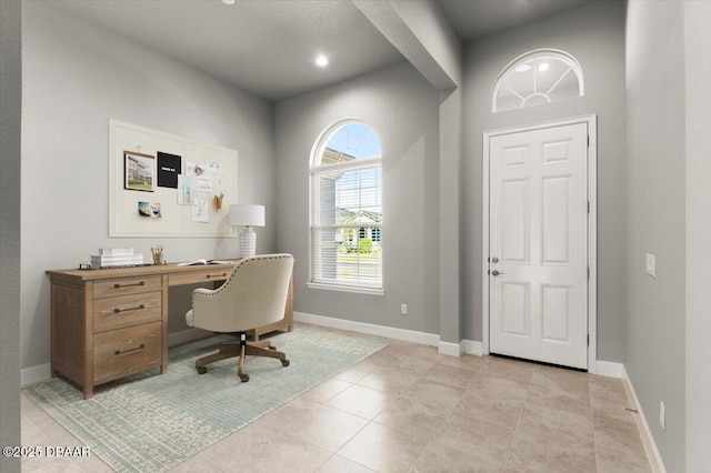 office area featuring light tile patterned floors and baseboards