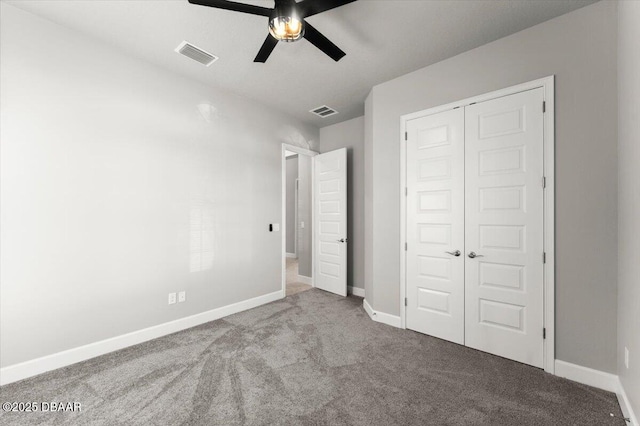 unfurnished bedroom featuring carpet, visible vents, a closet, and baseboards