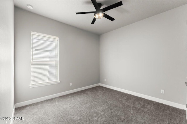 empty room featuring carpet flooring, a ceiling fan, and baseboards