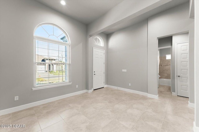 foyer entrance with baseboards and light tile patterned flooring