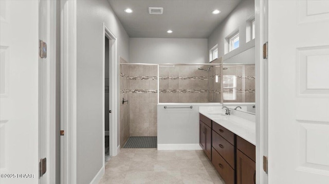 full bathroom featuring vanity, recessed lighting, and walk in shower