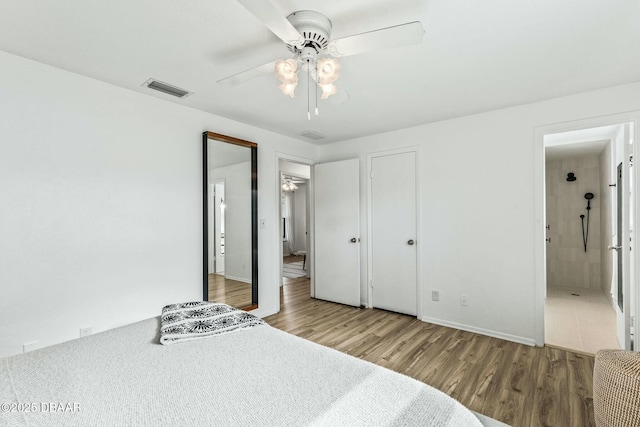 bedroom featuring wood-type flooring, ceiling fan, and ensuite bathroom