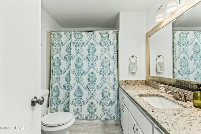 bathroom with vanity, walk in shower, tile patterned floors, and toilet