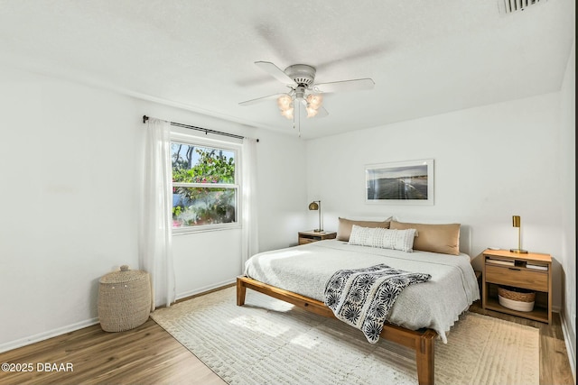 bedroom featuring hardwood / wood-style flooring and ceiling fan