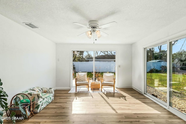 sunroom / solarium with ceiling fan and a wealth of natural light