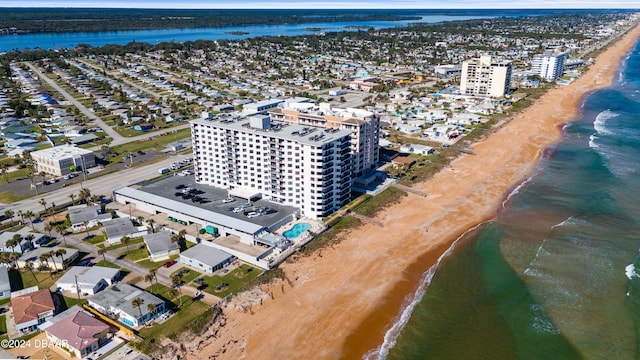 birds eye view of property featuring a water view and a beach view