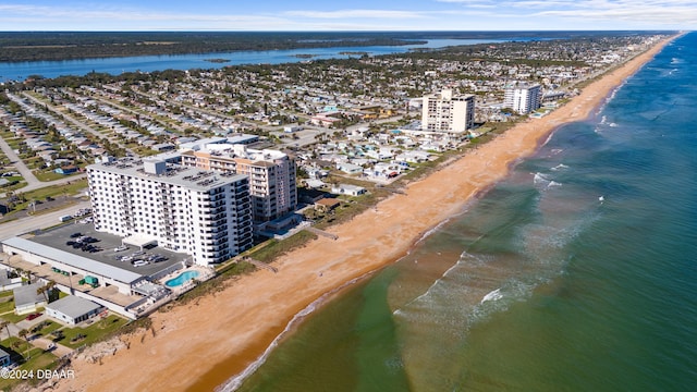 birds eye view of property with a beach view and a water view