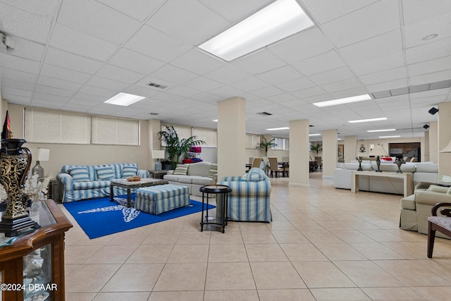 tiled living room featuring a drop ceiling