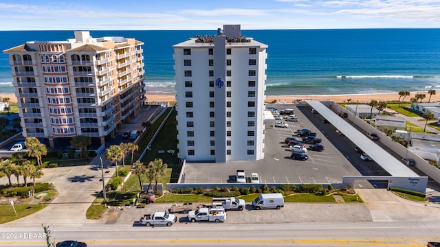 drone / aerial view featuring a water view and a beach view