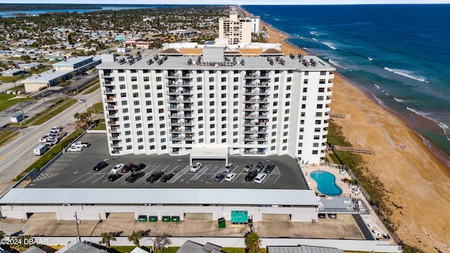 drone / aerial view with a beach view and a water view