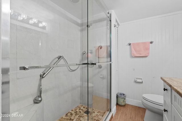 bathroom featuring vanity, wooden walls, toilet, an enclosed shower, and wood-type flooring