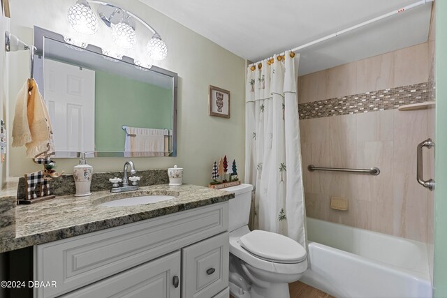 full bathroom with vanity, shower / tub combo, and toilet