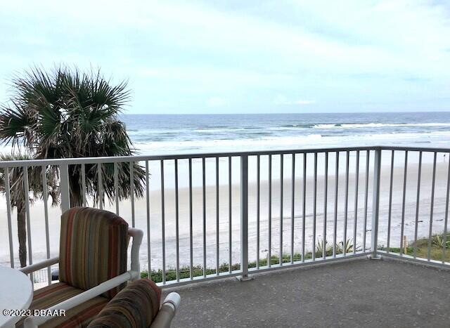 balcony with a beach view and a water view