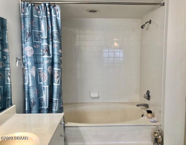 bathroom with shower / tub combo and vanity