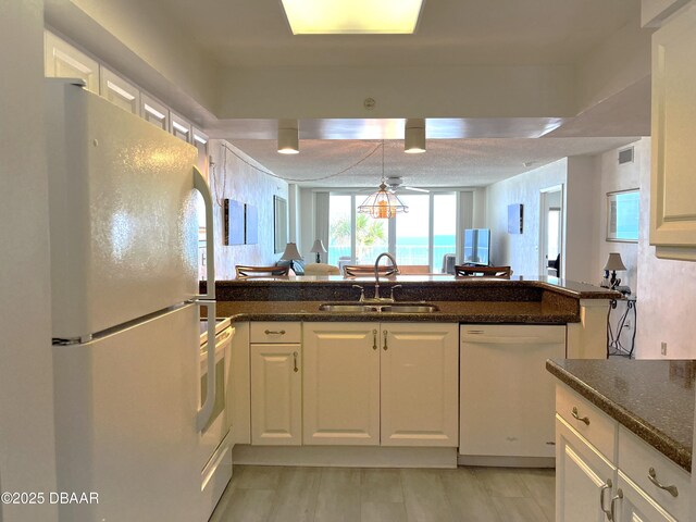 kitchen featuring white cabinets, light hardwood / wood-style floors, and ceiling fan