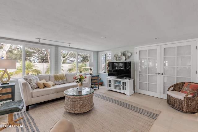 living room with light tile patterned flooring and french doors