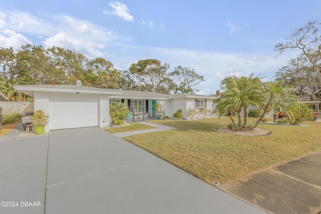 single story home featuring a garage and a front lawn