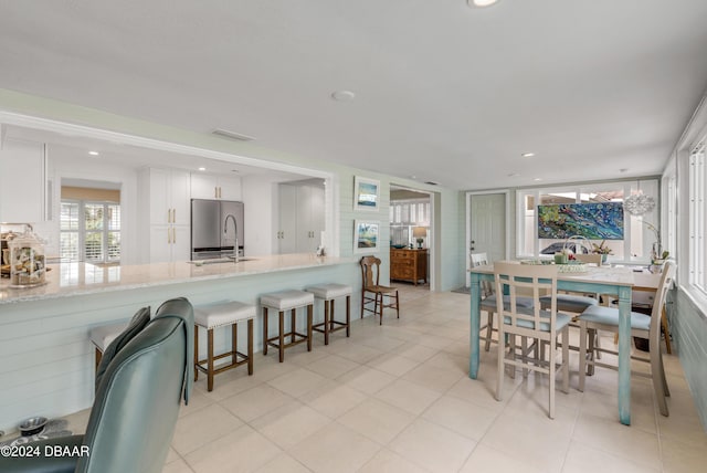 tiled dining area featuring sink