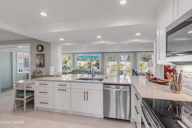 kitchen featuring white cabinets, light stone countertops, sink, and appliances with stainless steel finishes