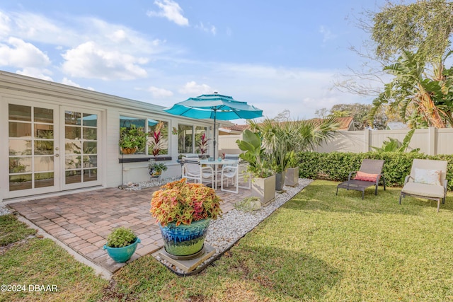 view of yard with french doors and a patio